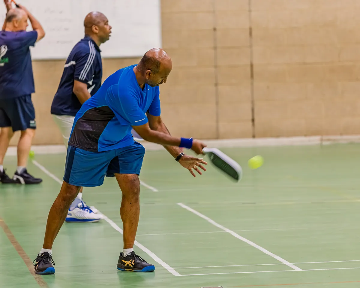 Players enjoying an indoor pickleball session at Northwood Pickleball Club